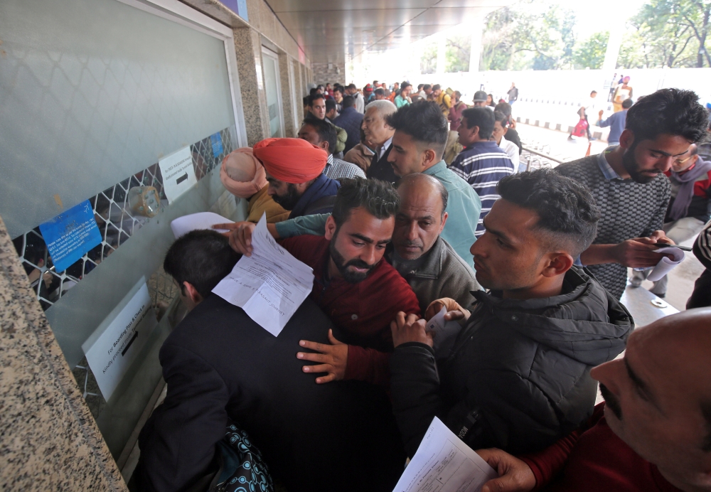 Passengers crowd a ticket counter outside the airport after their flight was canceled following temporarily suspension of flights, in Jammu, India, on Wednesday. — Reuters