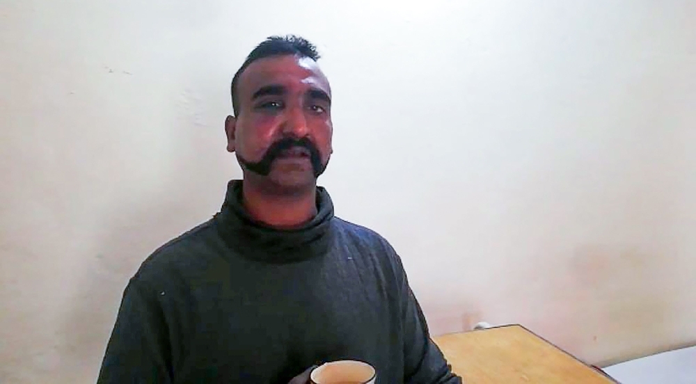 Indian pilot looks on as holding a cup of tea in the custody of Pakistani forces in an undisclosed location on Wednesday. — AFP