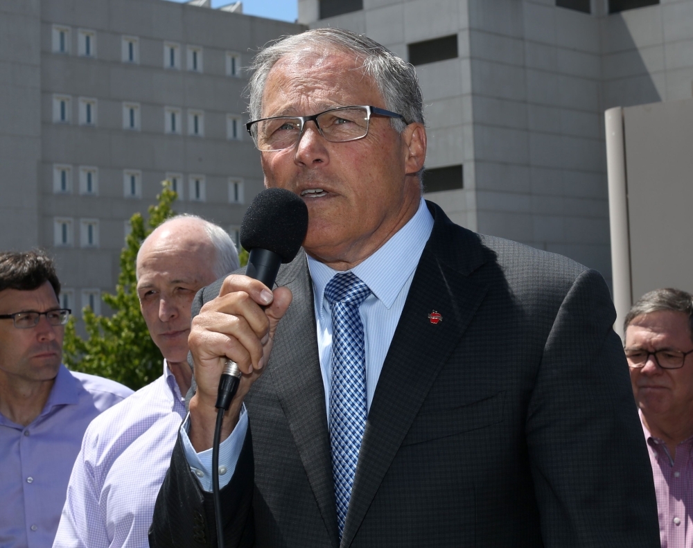 Washington State Governor Jay Inslee speaks at a press conference outside a Federal Detention Center holding migrant women at Seattle-Tacoma International Airport in Seattle, Washington, in this June 9, 2018 file photo. — AFP