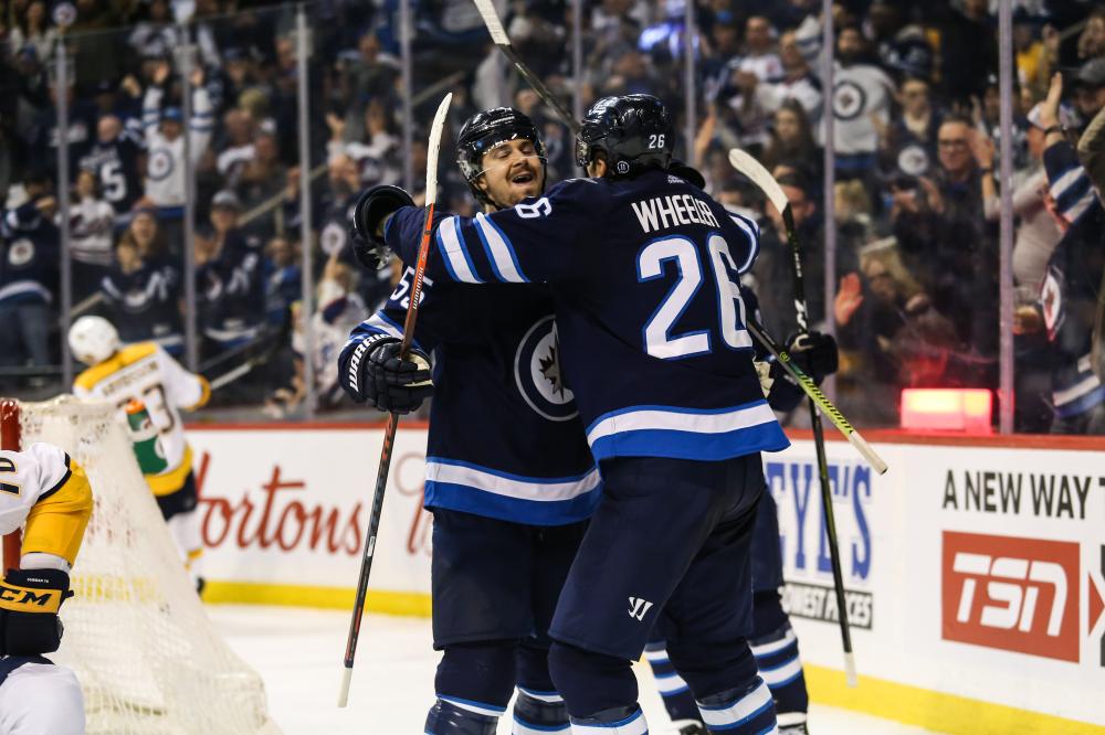 Winnipeg Jets’ forward Mark Scheifele (L) celebrates with teammate Blake Wheeler after scoring a goal against the Nashville Predators during their NHL game at Bell MTS Place in Winnipeg Friday. — Reuters
