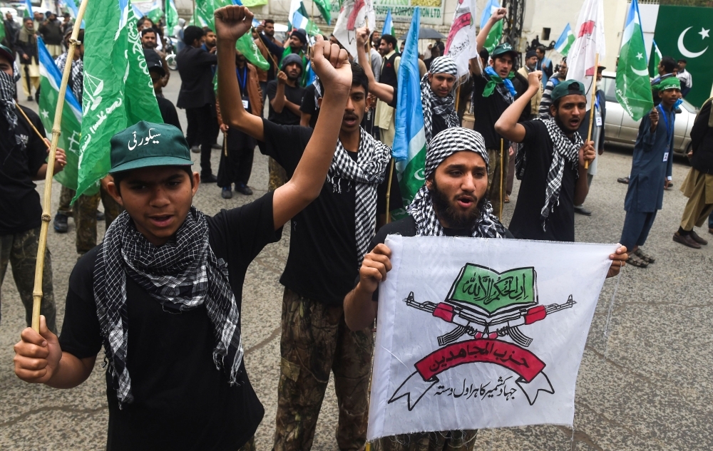 Pakistani demonstrators hold flags and shout slogans during an anti-Indian protest in Lahore. Tensions between India and Pakistan raged as heavy firing by their armies killed at least seven people on either side of their fiercely disputed Kashmir border on Saturday.  — AFP