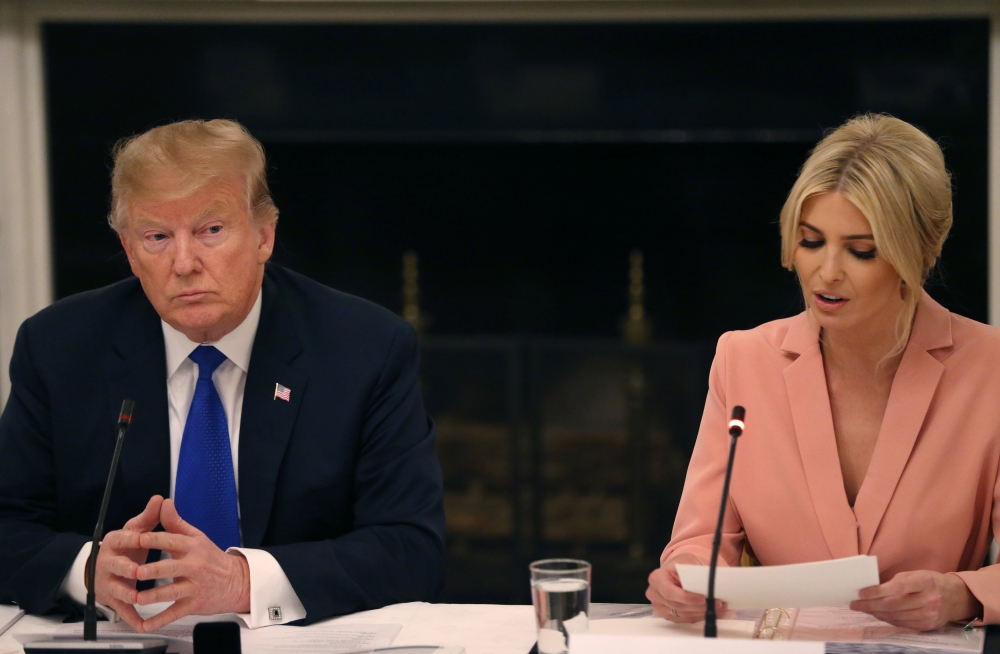 US President Donald Trump listens to his daughter and White House senior adviser Ivanka Trump speak as he participates in an American Workforce Policy Advisory Board meeting in the White House State Dining Room in Washington on Wednesday. — Reuters