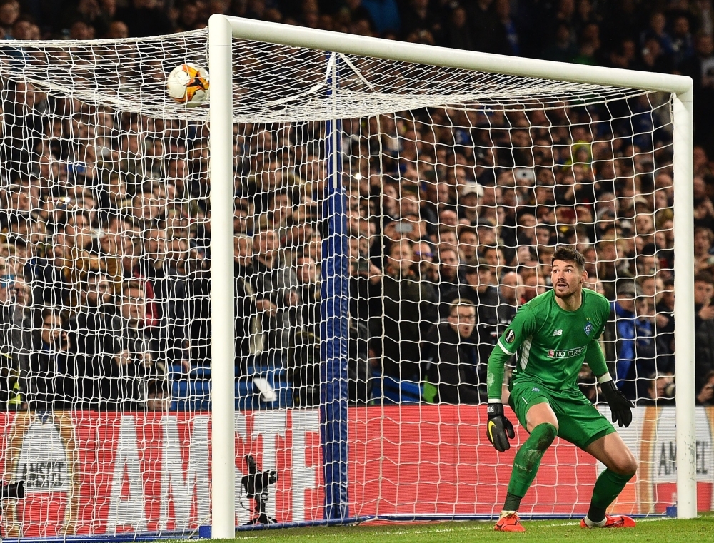 Dynamo Kiev's Ukrainian goalkeeper Denys Boyko watches as a freekick from Chelsea's Brazilian midfielder Willian makes the score 2-0 during the first leg of the UEFA Europa League round of 16 football match between Chelsea and Dynamo Kiev at Stamford Bridge stadium in London on Thursday. — AFP