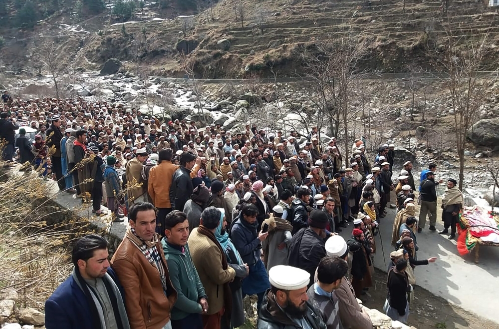 Pakistani residents offer funeral prayers beside the coffin of Afzal Kohistani, who was killed by gunmen, in Battagram District in Khyber Pakhtunkhwa province, on Friday. — AFP