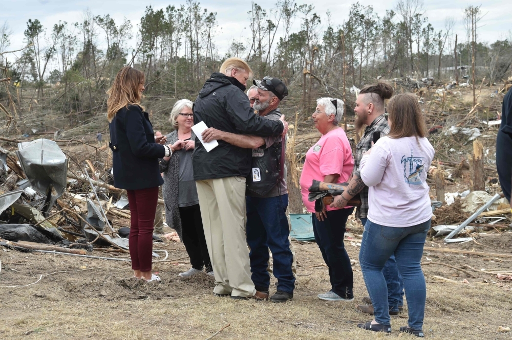 US President Donald Trump greets residents during a tour of tornado-affected areas in Beauregard, Alabama, on Friday. — AFP