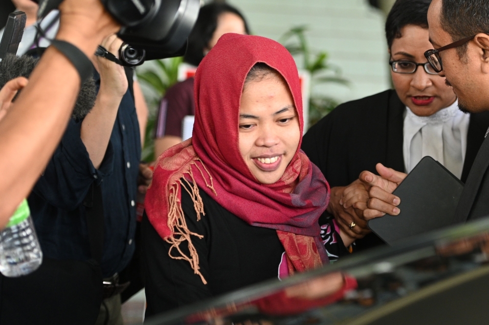 Indonesian national Siti Aisyah, center, smiles while leaving the Shah Alam High Court outside Kuala Lumpur on Monday. — AFP