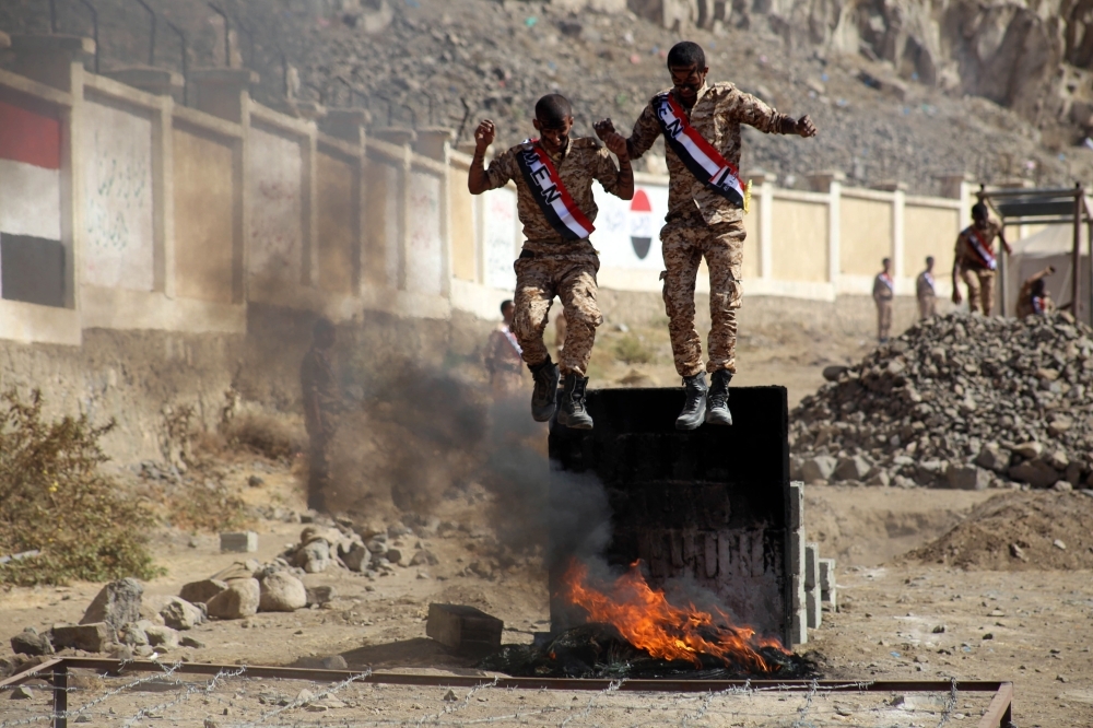 Yemeni fighters from the Popular Resistance Committees, supporting forces loyal to Yemen’s Saudi-backed government, take part in a graduation ceremony in the country’s third city Taez, on Monday.  — AFP