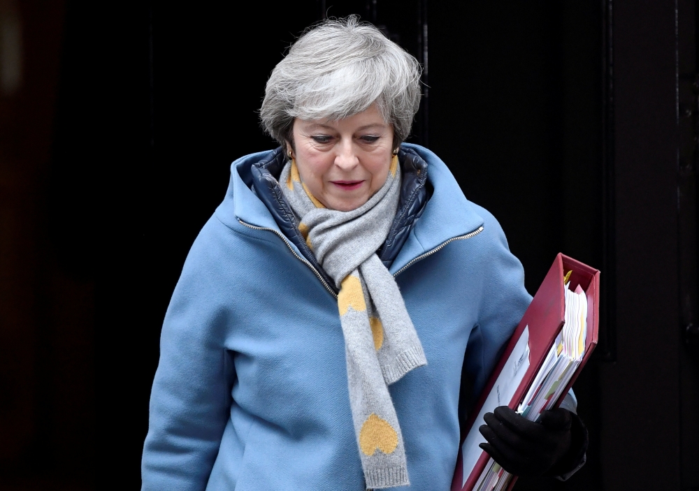 British Prime Minister Theresa May walks outside Downing Street, as she faces a vote on Brexit in London, Britain, on Wednesday. — Reuters