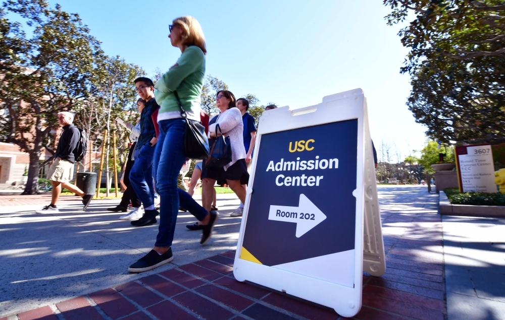 Adults and prospective students tour the University of Southern California (USC) in Los Angeles, California, Wednesday.  