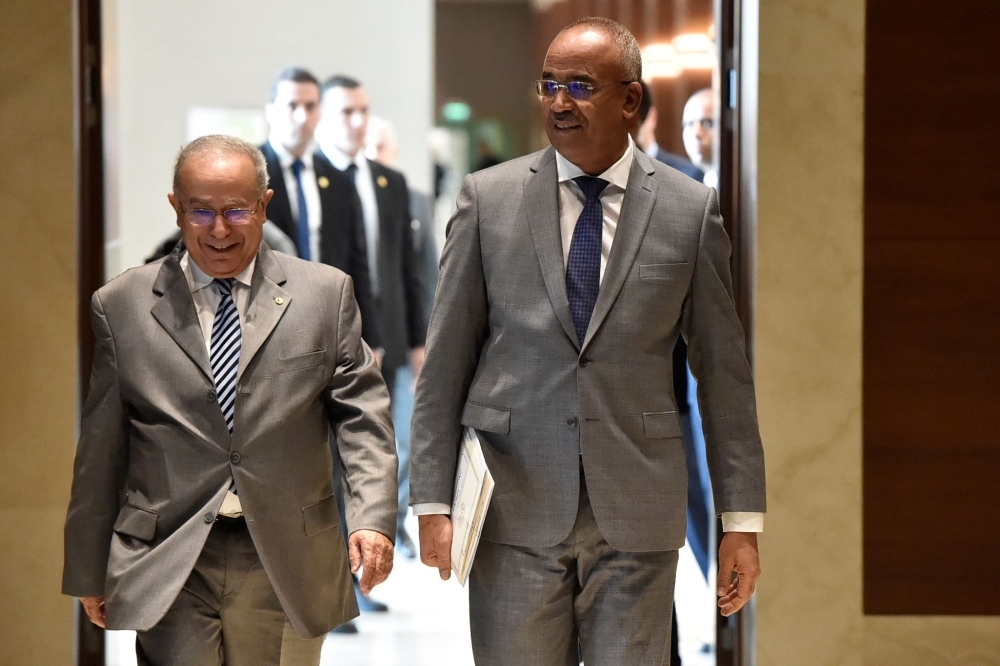 Newly appointed Algeria's prime minister Noureddine Bedoui (right) arrives for a press conference with his deputy Ramtane Lamamra in Algiers, Thursday. — AFP