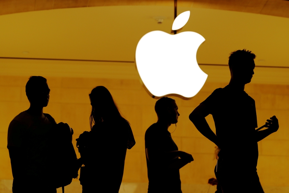 Customers walk past an Apple logo inside of an Apple store at Grand Central Station in New York, US, in this file photo. — Reuters