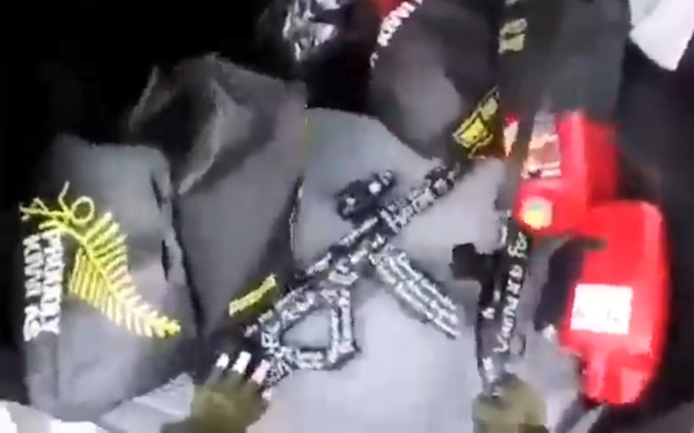 This image grab from a self-shot video that was streamed on Facebook Live on Friday by the man who was involved in two mosque shootings in Christchurch shows the man reaching for guns from the boot of his car before he enters the Masjid Al Noor . — AFP