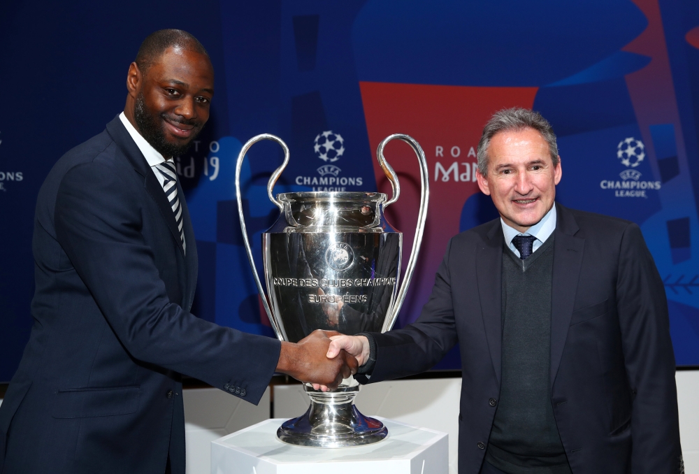 Manchester United club ambassador Andrew Cole shakes hands with FC Barcelona Sporting Driector Eric Abidal after the Champions League draw in Nyon, Switzerland. — Reuters