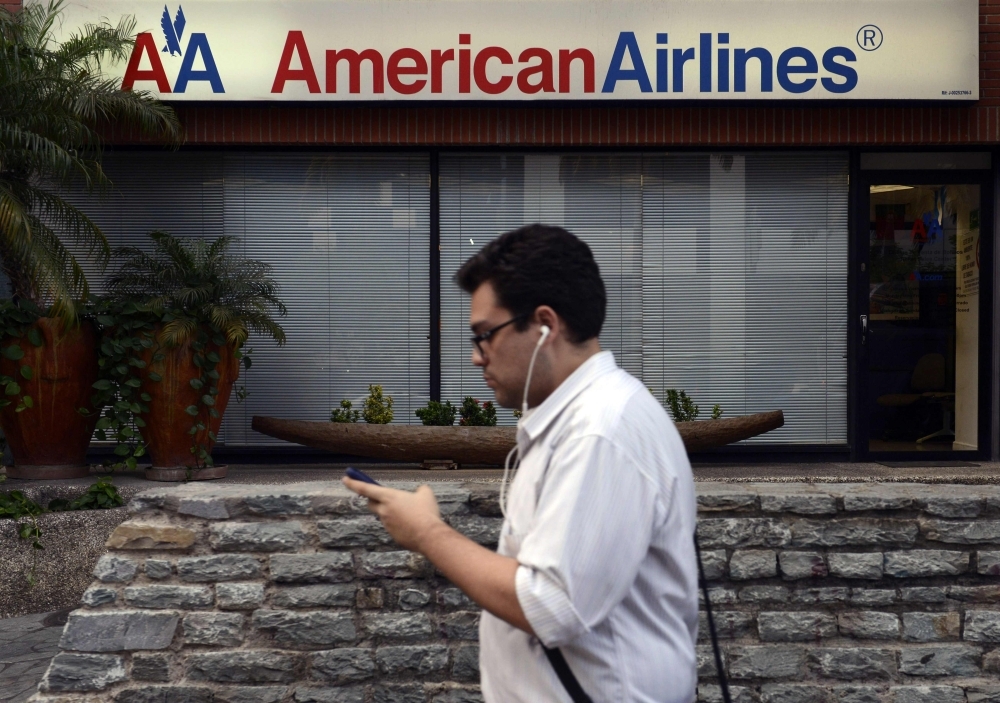A man walks next to an American Airlines ticket sale office in Caracas in this June 17, 2014 file photo. — AFP