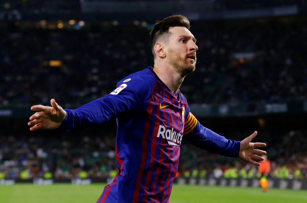 Barcelona’s Lionel Messi celebrates scoring their fourth goal to complete his hat trick in La Liga Santander match against Real Betis at Estadio Benito Villamarin, Seville, Sunday. — Reuters