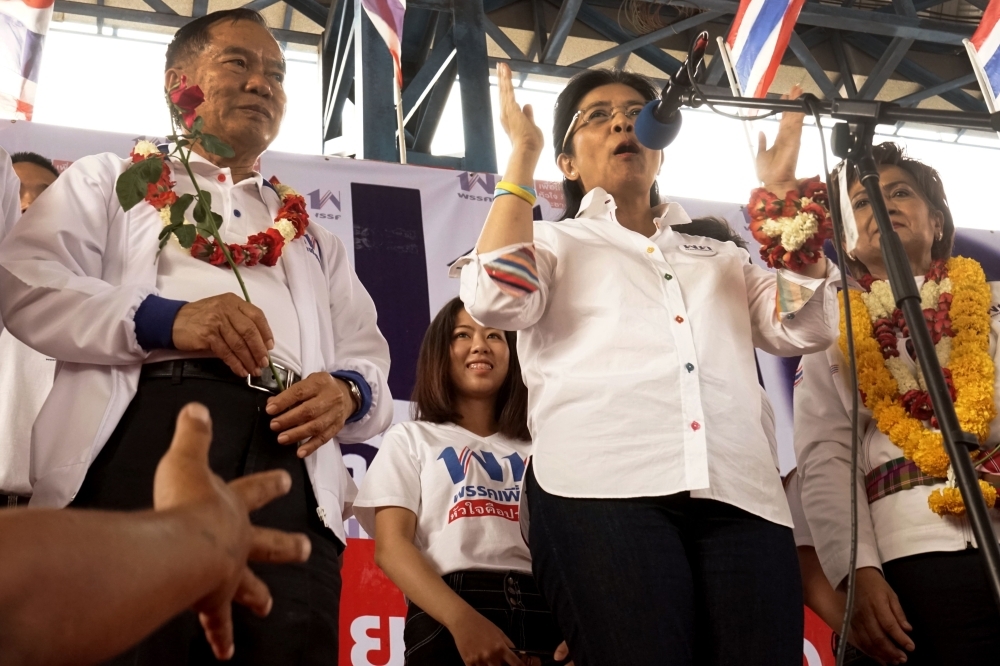 Pheu Thai party candidate for prime minister Sudarat Keyuraphan, center, speaks during a rally in Chaiyaphum province on Monday, ahead of the March 24 general election.  — AFP