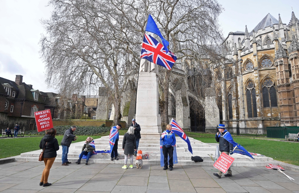 Anti-Brexit protesters gather opposite the Houses of Parliament in London on Monday. — Reuters