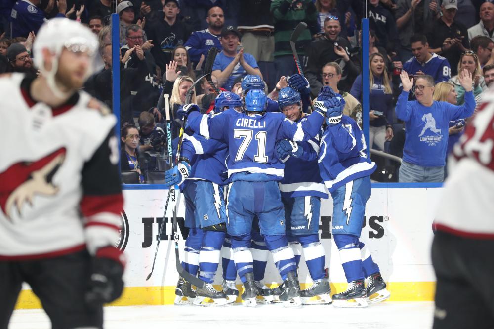 Tampa Bay Lightning players celebrate after beating the Arizona Coyotes during their NHL game at Amalie Arena in Tampa Monday. — Reuters