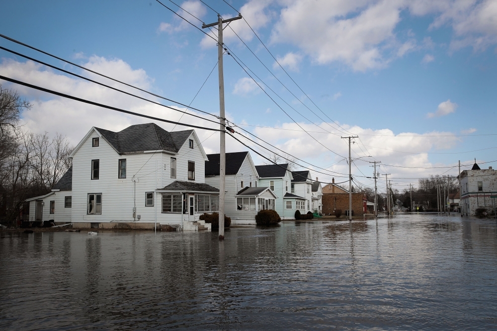 Homes are surrounded by floodwater from the Pecatonica River in Freeport, Illinois, on Monday. — AFP