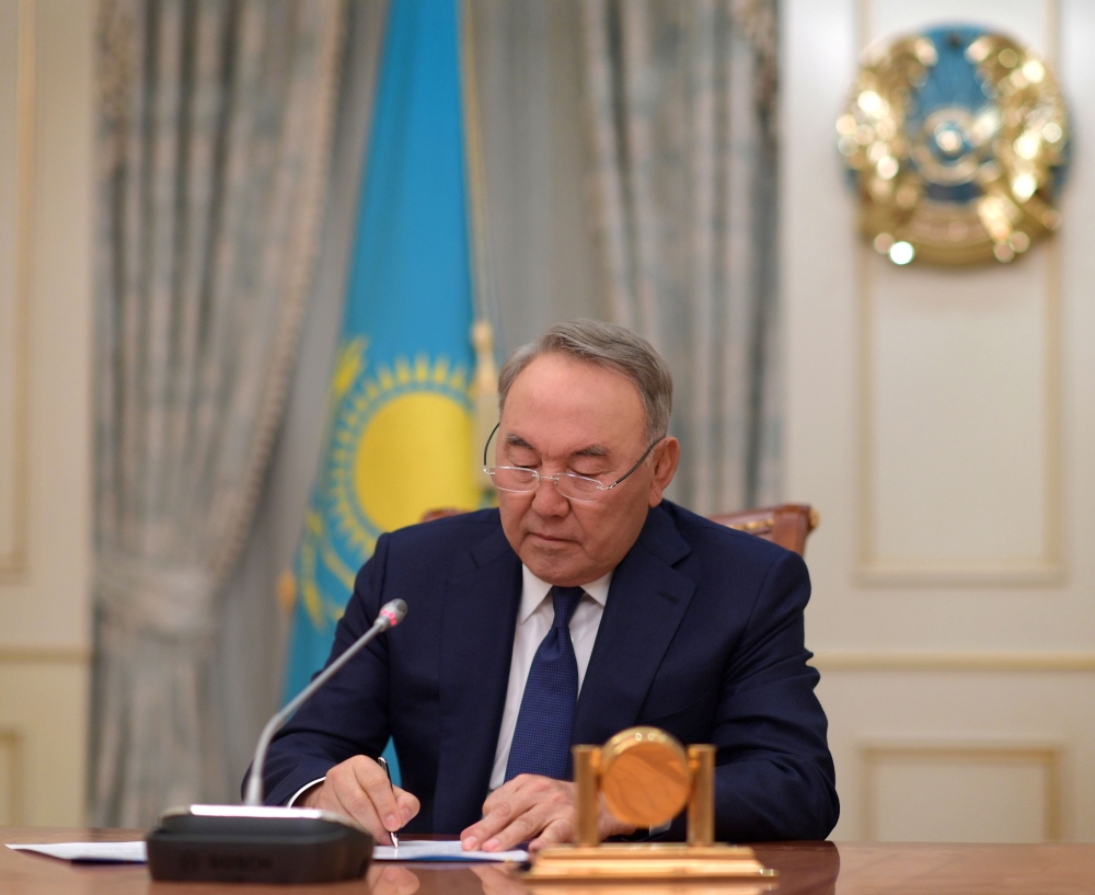 Kazakhstan’ss President Nursultan Nazarbayev writes during a televised address to inform of his resignation in Astana, Kazakhstan, on Tuesday. — Reuters