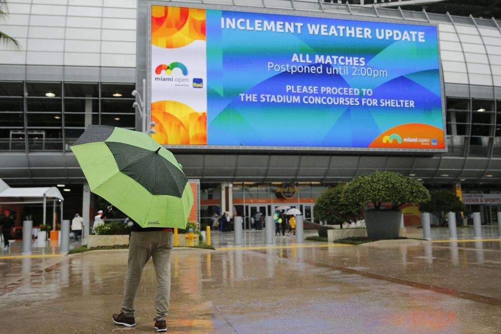 Fans walk through the tennis complex as matches are postponed on Day 2 of the Miami Open in Miami Gardens, Florida, Tuesday. — AFP 
