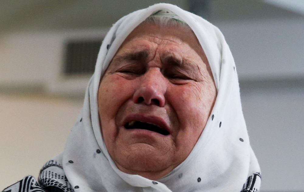 A woman reacts after the verdict on former Bosnian Serb political leader Radovan Karadzic’s appeal of his 40 year sentence for war crimes, in the Memorial center Potocari near Srebrenica, Bosnia and Herzegovina, on Wednesday. — Reuters