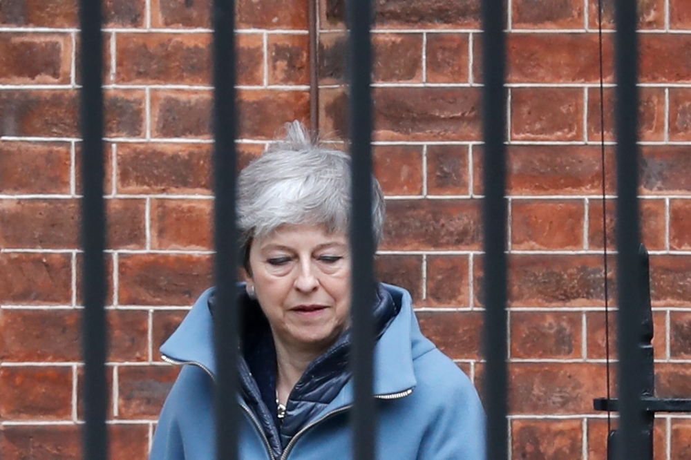 Britain’s Prime Minister Theresa May leaves Downing street in London on Thursday. — AFP