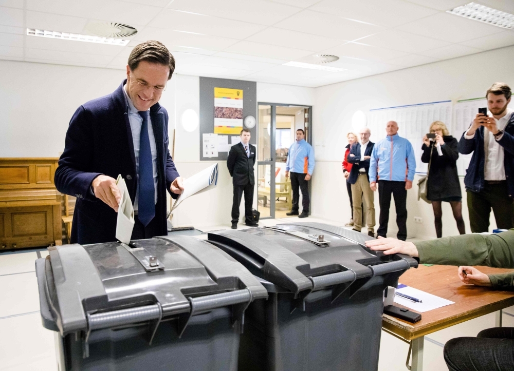 Dutch Prime Minister Mark Rutte casts his ballot for Netherlands’ provincial and water authorities elections at a polling station in Wolters primary school in The Hague on Wednesday. — AFP