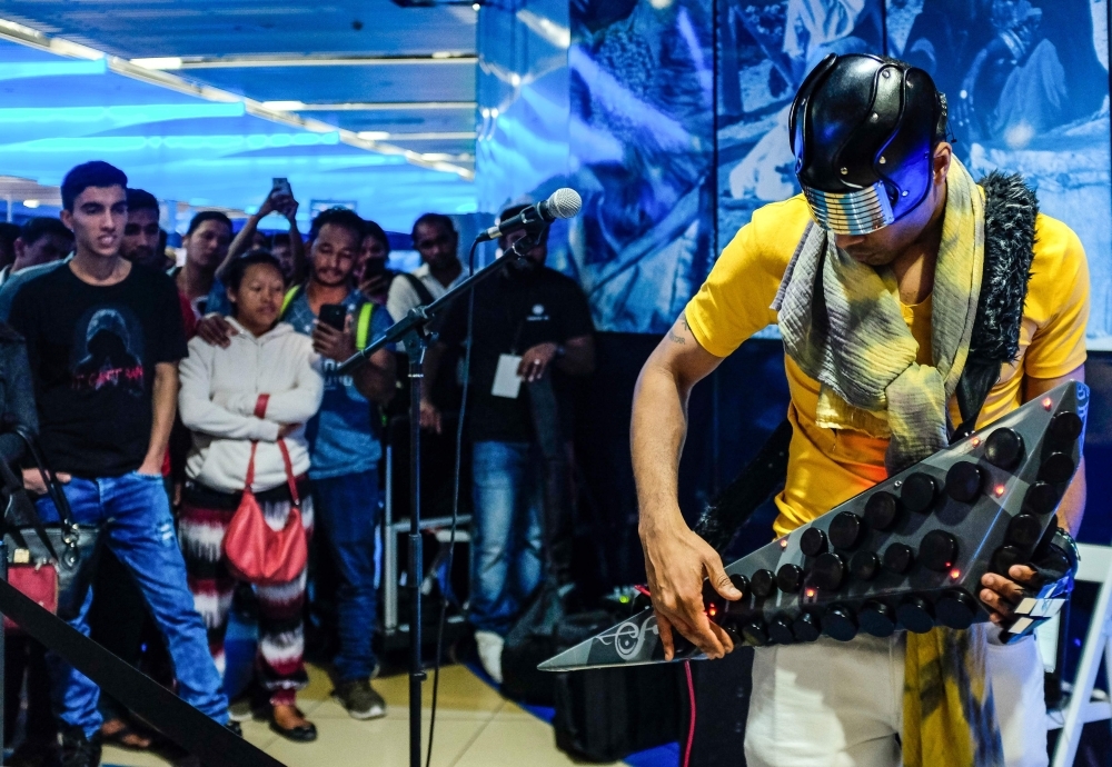 A man uses his phone to film artist Omar Hamdan performing using Buzuq instrument as part of Dubai Metro Music Festival at Bur Juman Metro station in Dubai on Wednesday. — AFP