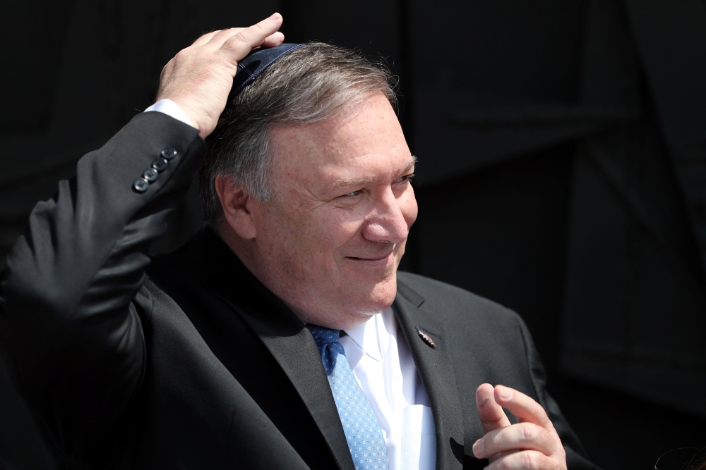 US Secretary of State Mike Pompeo touches his Jewish skullcap during his visit to Yad Vashem World Holocaust Remembrance Center in Jerusalem on Thursday. — Reuters