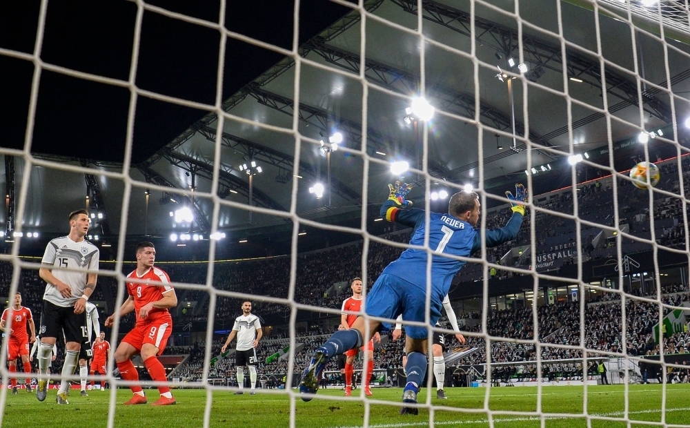 Serbia's forward Luka Jovic (2nd from L) hits the ball past Germany's goalkeeper Manuel Neuer during the friendly football match Germany v Serbia in Wolfsburg, western Germany on Wednesday. — AFP