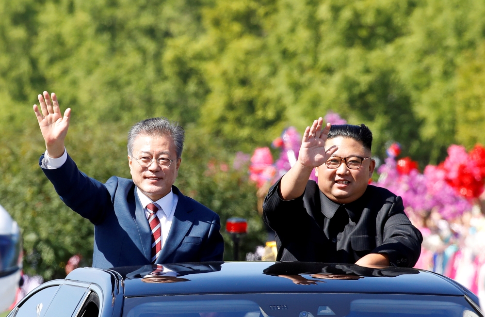 South Korean President Moon Jae-in and North Korean leader Kim Jong Un wave during a car parade in Pyongyang, North Korea, in this Sept. 18, 2018 file photo. — Reuters