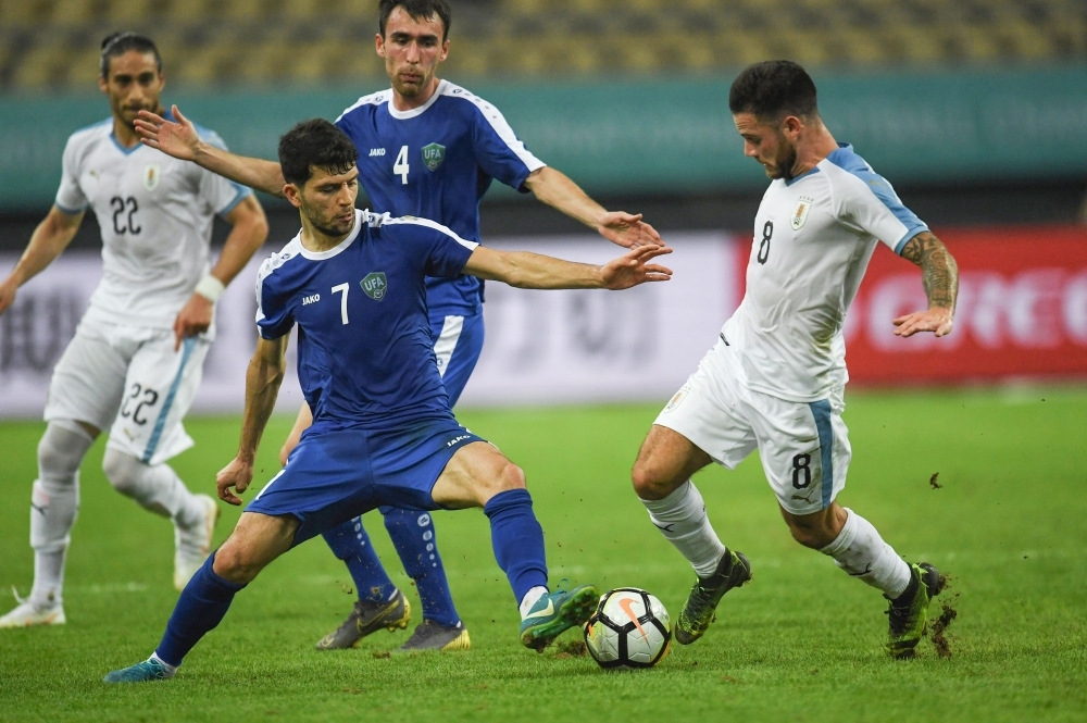 Nahitan Nandez (R) of Uruguay competes for the ball with Jaloliddin Masharipov of Uzbekistan during the 2019 China Cup football match between Uruguay and Uzbekistan in Nanning in China's southern Guangxi region on Friday. — AFP