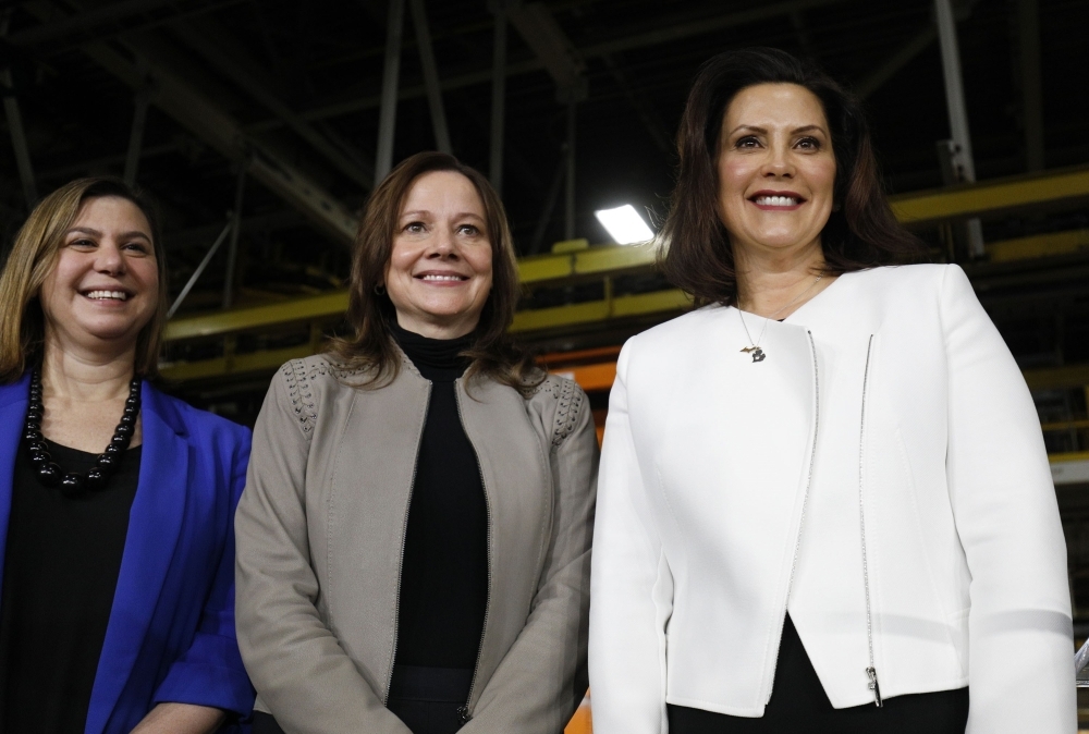 General Motors Chairman and CEO Mary Barra (C) stands on stage with Michigan Gov. Gretchen Whitmer (R) and Rep. Elissa Slotkin (D-MI) after she announced a $300 million investment in the GM Orion Assembly Plant plant for electric and self-driving vehicles at the Orion Assembly Plant on Friday in Lake Orion, Michigan.   — AFP