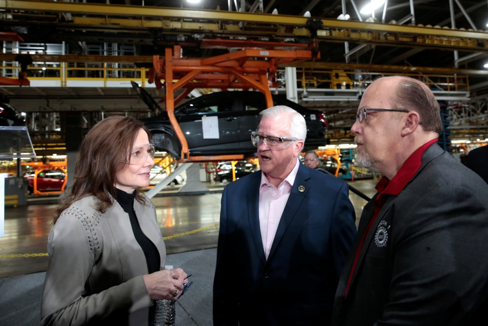 General Motors Chairman and CEO Mary Barra (C) stands on stage with Michigan Gov. Gretchen Whitmer (R) and Rep. Elissa Slotkin (D-MI) after she announced a $300 million investment in the GM Orion Assembly Plant plant for electric and self-driving vehicles at the Orion Assembly Plant on Friday in Lake Orion, Michigan.   — AFP