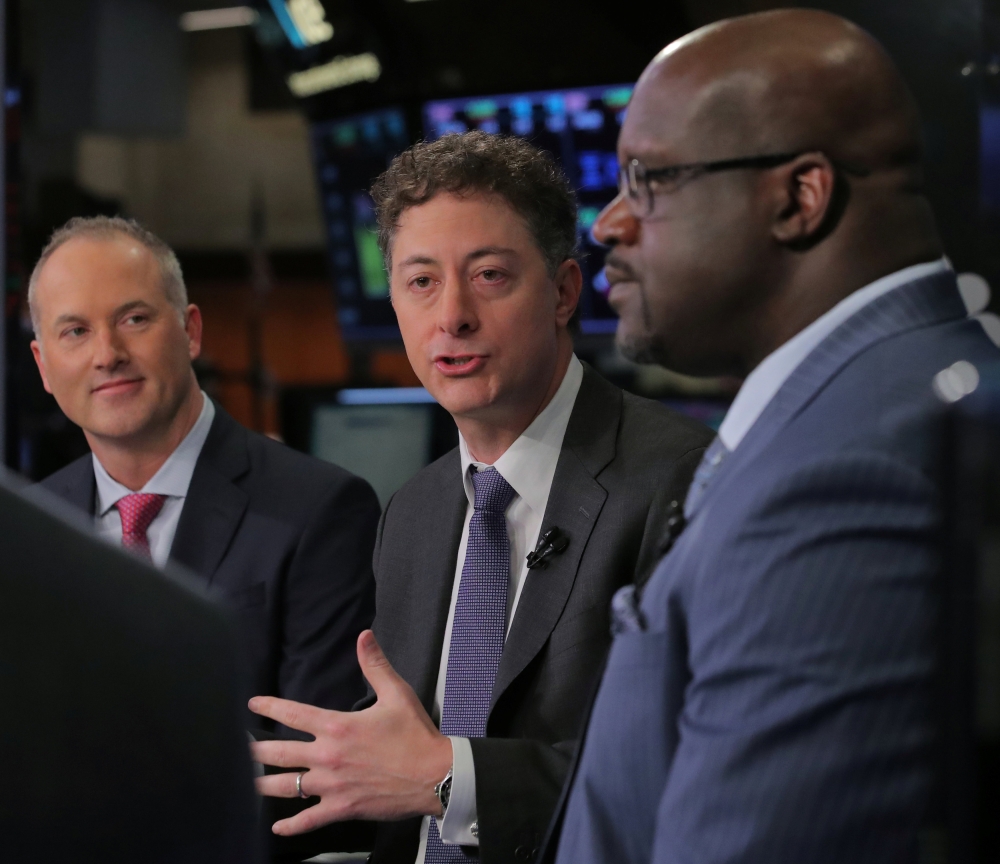 Jeffrey Smith, CEO of Starboard Value LP and chairman of Papa John's International Inc., speaks with Steve Ritchie, CEO of Papa John's, and former basketball star, Shaquille O'Neal, during an interview on CNBC on the floor of the New York Stock Exchange (NYSE) in New York, US, Friday. — Reuters