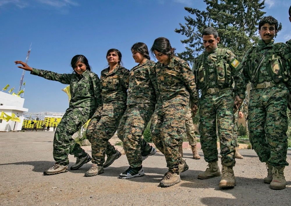 


Fighters of the US-backed Kurdish-led Syrian Democratic Forces (SDF) dance as they celebrate near the Omar oilfield in the eastern Syrian Deir Ezzor province on Saturday, after announcing the total elimination of the Daesh group's last bastion in eastern Syria. — AFP