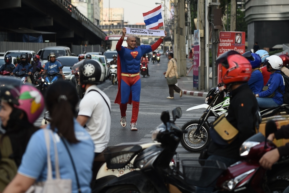 


Thai-German national David Pfizenmaier performs a bike stunt whilst encouraging Thais to vote in the upcoming election in Bangkok. – AFP