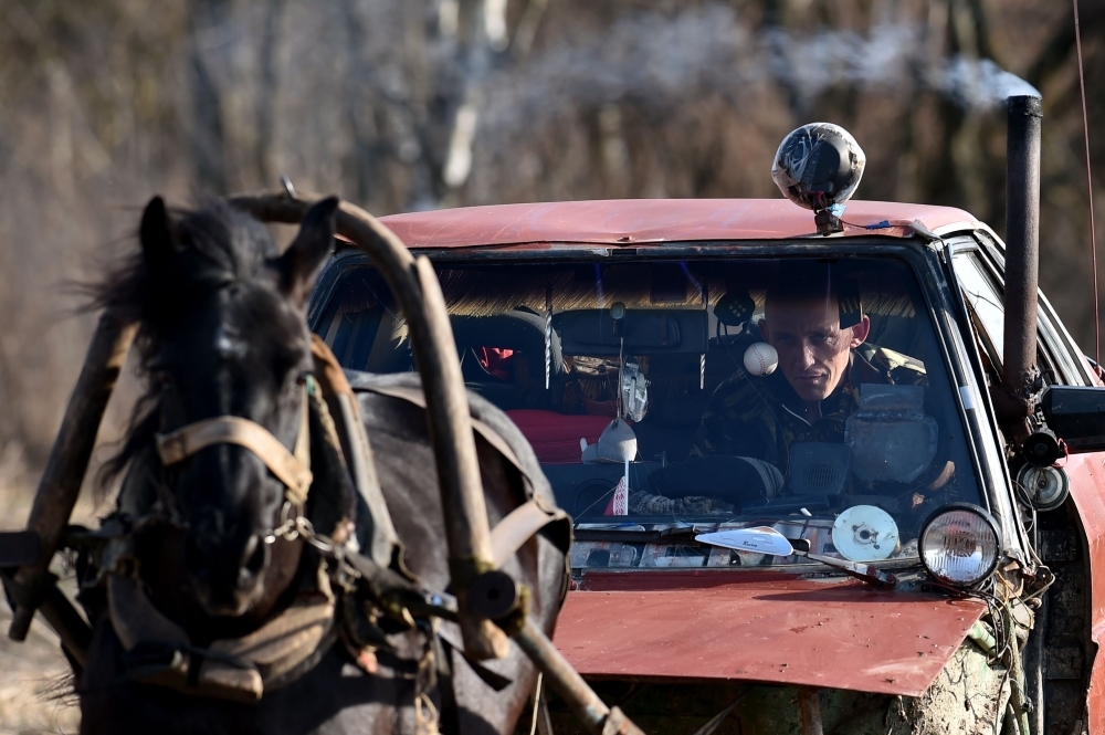 


Farmer Alexei Usikov, 31, rides his horse-pulled cart made from an old Audi 80 car in the village of Knyazhitsy, some 230 km east of Minsk. — AFP