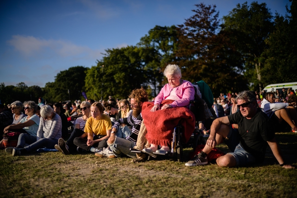 People on Sunday attend a vigil in memory of the twin mosque massacre victims in Christchurch. New Zealand will hold a national remembrance service for victims of the Christchurch massacre on March 29, the government announced, as the country grieves over a tragedy that shocked the world. — AFP