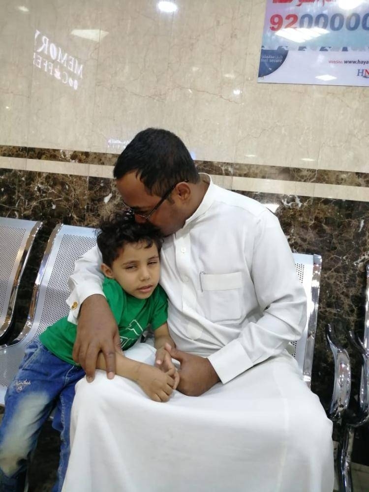 


Five-year-old Mohammed, who survived the deadly accident that critically injured his mother, clings to his father Hussain Ali Mohammed while waiting at the hospital in Khamis Mushayt.