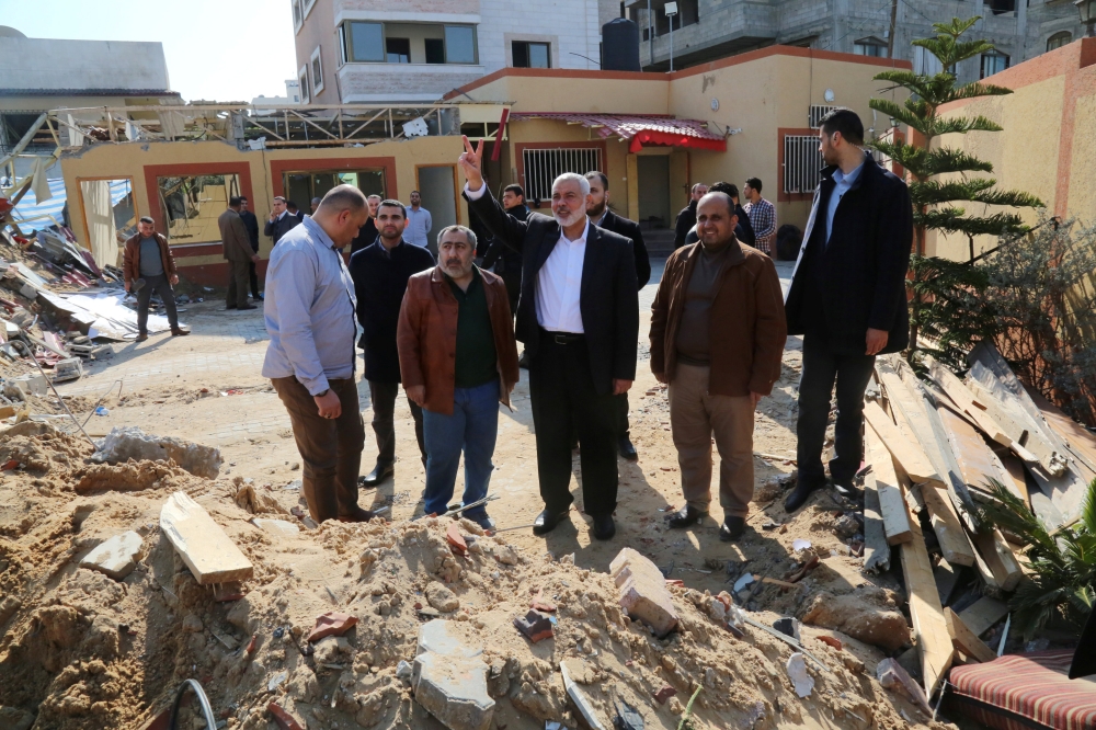 Hamas chief Ismail Haniyeh, center, visits his office that was targeted in an Israeli air strike in Gaza City on Wednesday. — Reuters