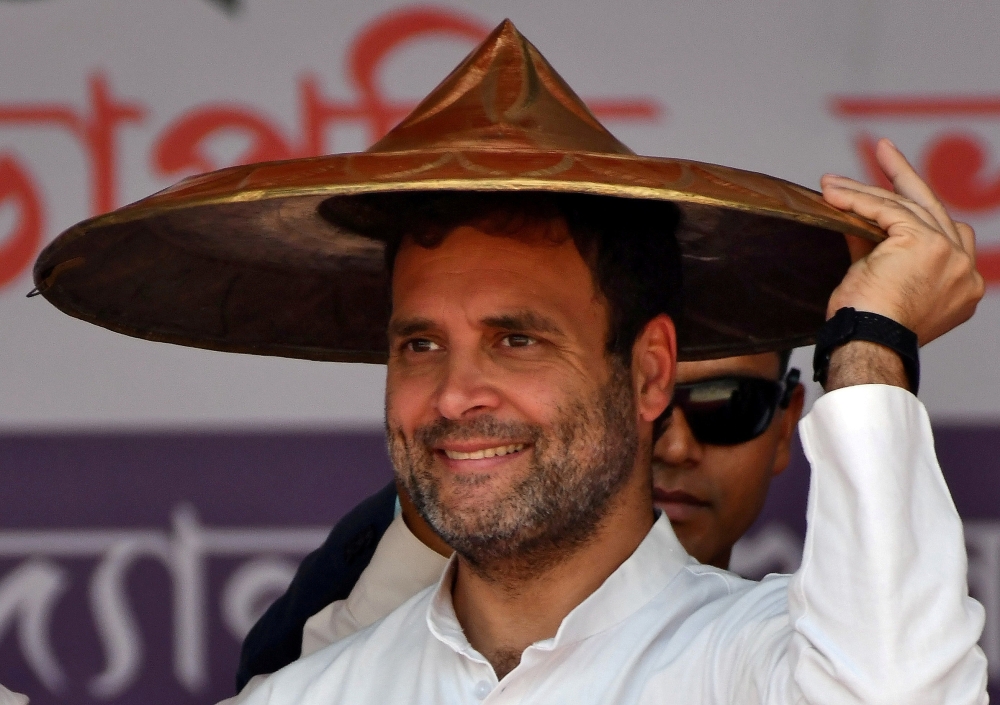 Rahul Gandhi, president of India’s main opposition Congress party, wears a “Japi” (a traditional hat of Assam) presented to him by party members during a rally in Guwahati, India, in this Feb. 26, 2019 file photo. — Reuters