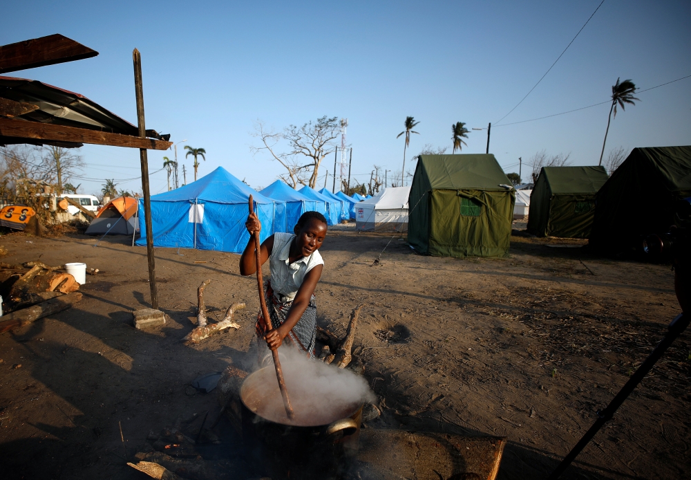 A woman prepares food at a camp for people displaced in the aftermath of Cyclone Idai in Beira, Mozambique, on Thursday. — Reuters