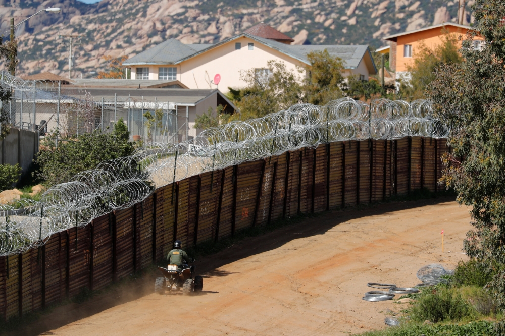 A US Customs and Border Patrol agent travels along the border wall between the US and Mexico near Tecate, California, on Thursday. — Reuters