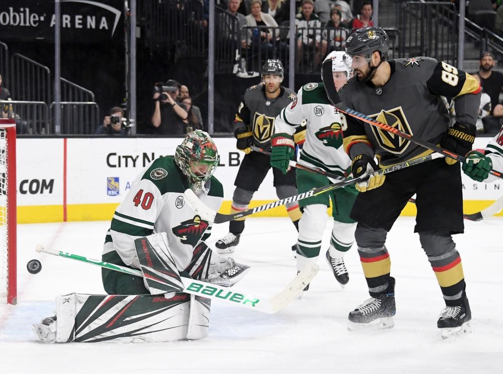 Devan Dubnyk of the Minnesota Wild blocks a shot as Alex Tuch (R) of the Vegas Golden Knights looks for a rebound during their NHL game at T-Mobile Arena in Las Vegas Friday. — AFP 