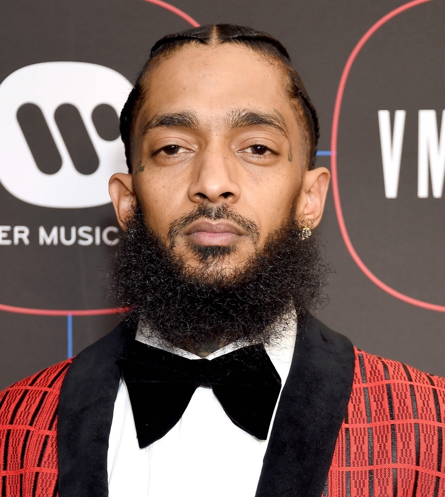 Blood stained bandages on the ground outside The Marathon clothing store owned by Grammy-nominated rapper Nipsey Hussle (INSET) where he was fatally shot along with 2 other wounded, in Los Angeles. — AFP