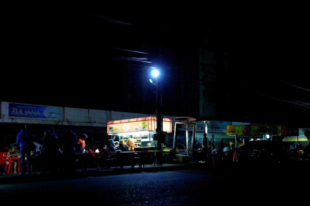 


Street food vendors whose stalls’ power is supplied by generators, work during a blackout in Maracaibo, Venezuela, in this March 31, 2019 file photo. — Reuters