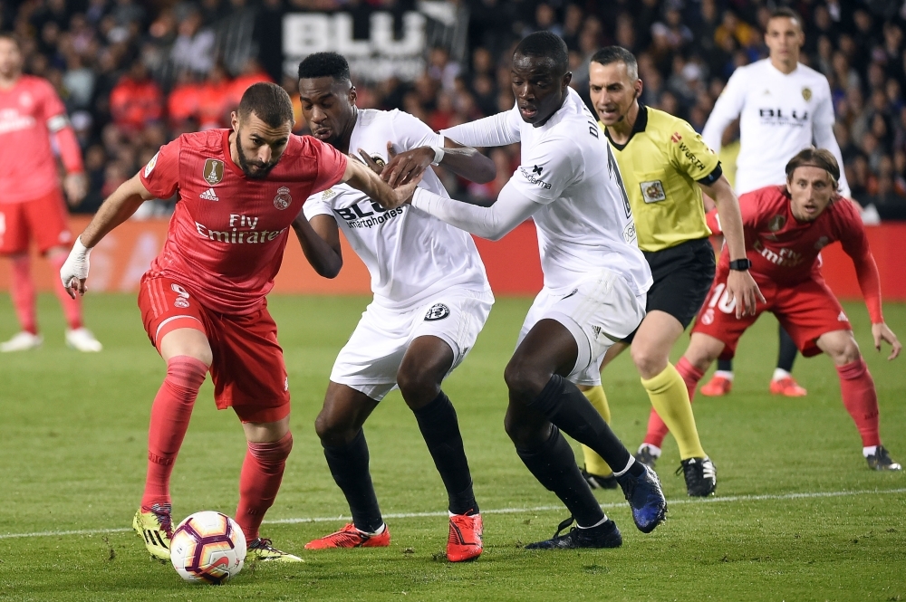 Real Madrid's French forward Karim Benzema (L) vies with Valencia's French midfielder Geoffrey Kondogbia (2L) and Valencia's French defender Mouctar Diakhaby during the Spanish league football match at the Mestalla Stadium in Valencia on Wednesday. — AFP
