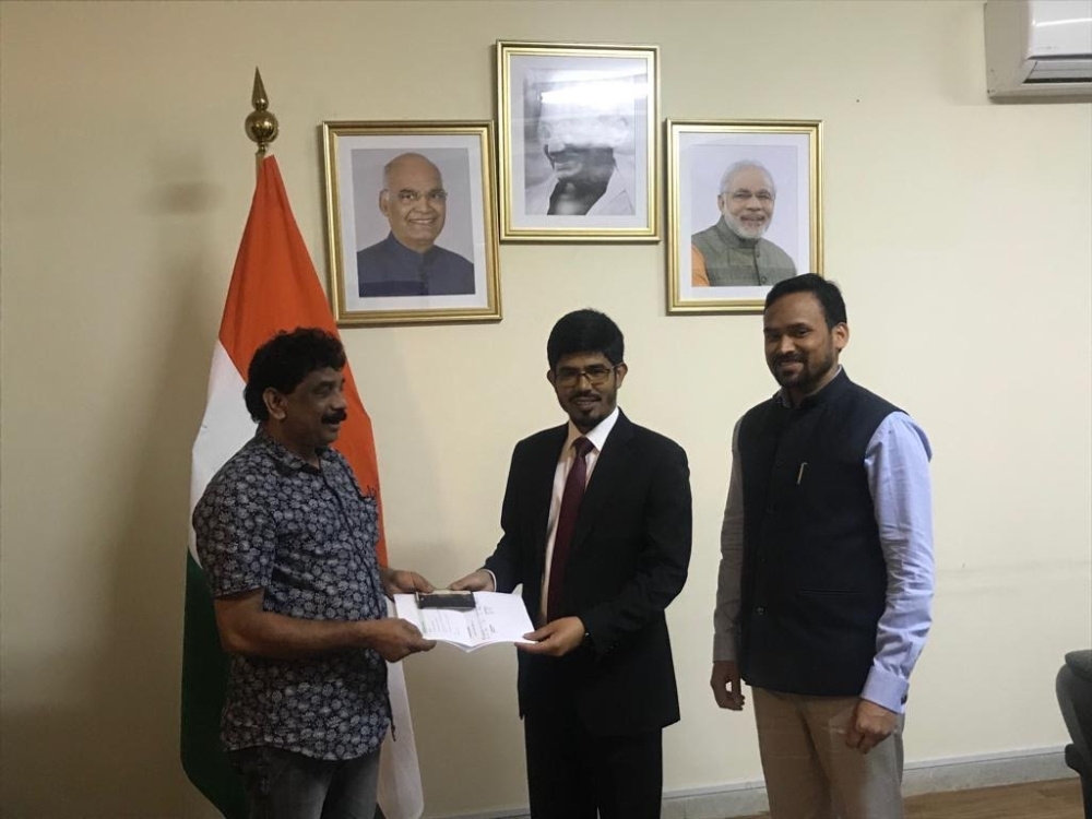 


Indian Consul General Md. Noor Rahman Sheikh hands Rajan Palakkundu Parambil travel documents for flying home.